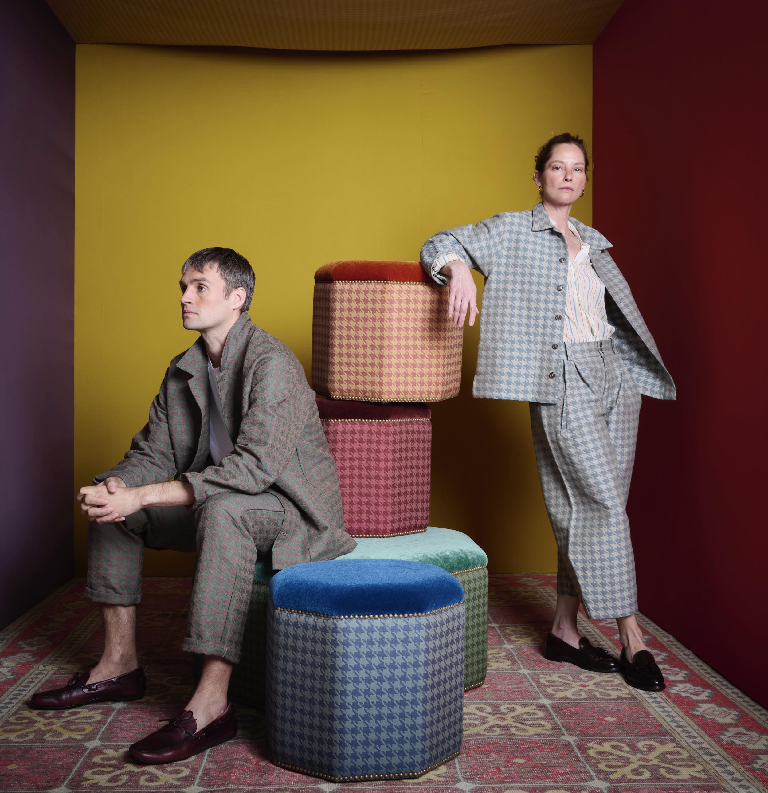 Nik wears work trouser and work jacket in heather houndstooth by Flora Soames, Sienna wears work jacket and dutch trousers in duck egg Flora Soames houndstooth Walter fabric