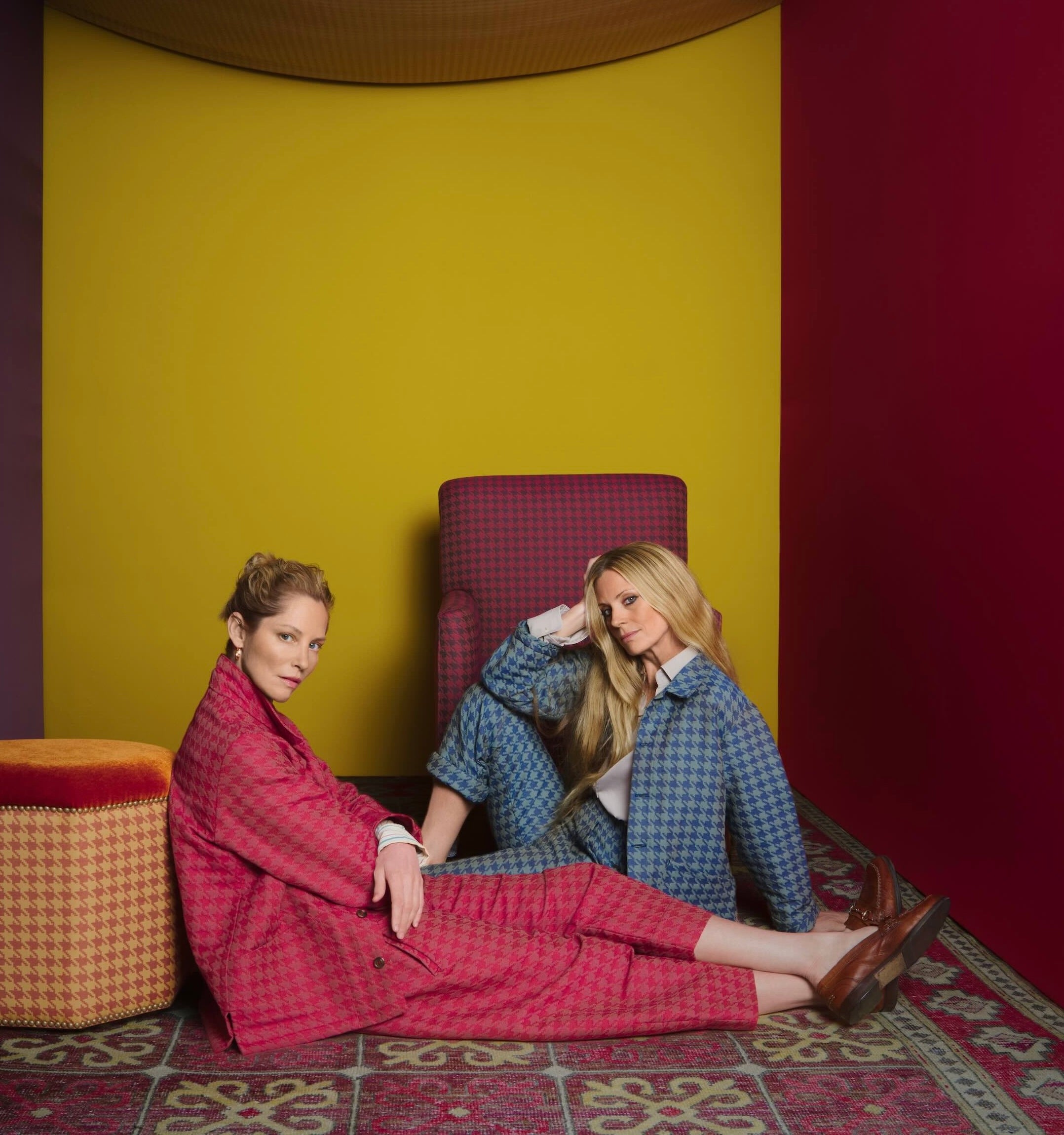 Sienna wea5rs work jacket and dutch trousers in crimson and Laura wears work trousers and work jacket in sea blue houndstooth