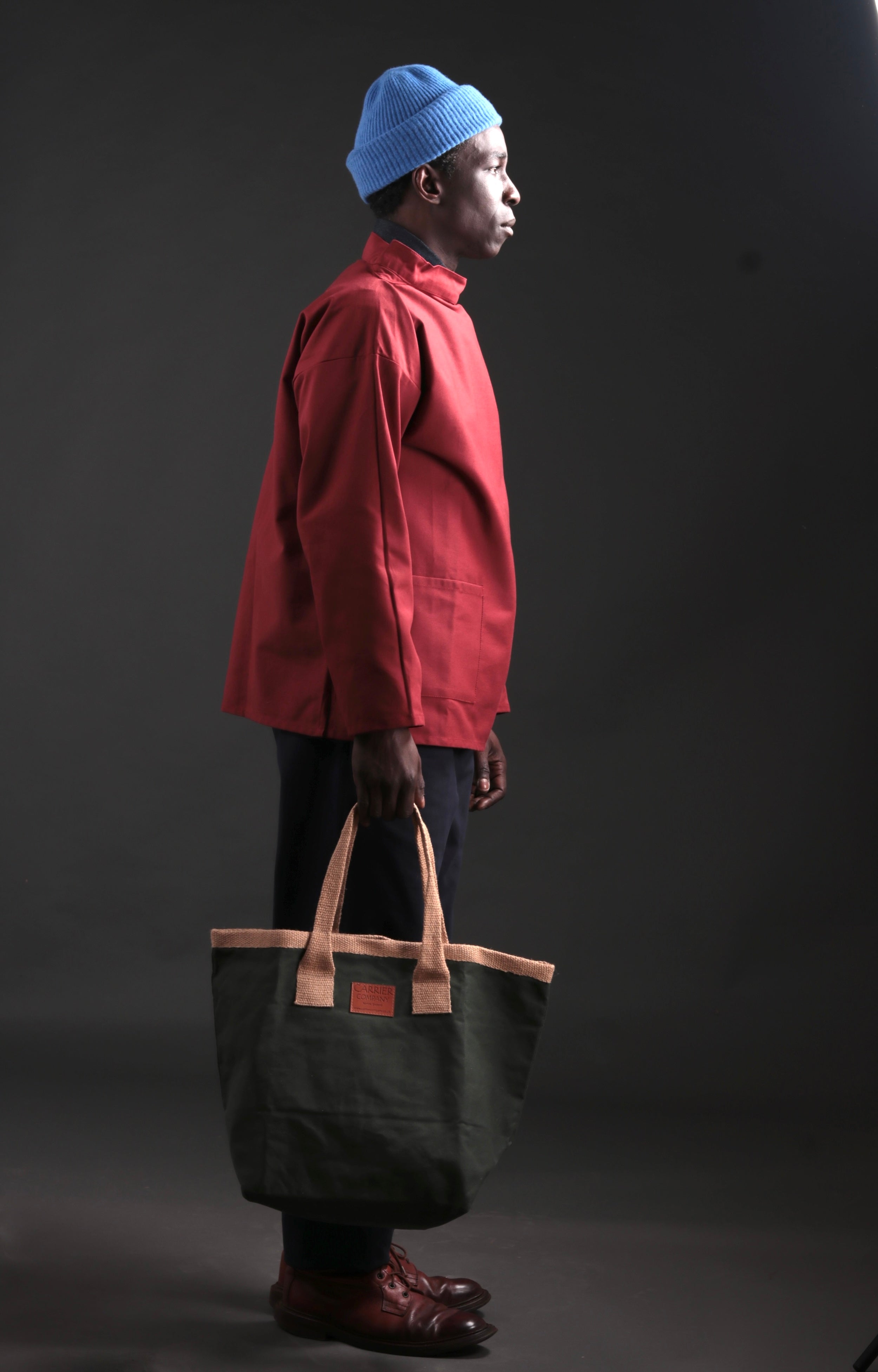 Man Carries Carrier Company Sturdy Bag in Spruce Green